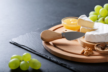 Sliced Camembert with knife on cheese board
