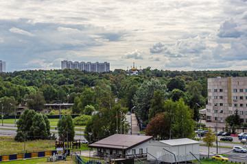 Domes of a Church surrounded by trees in a large city Park