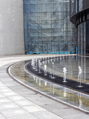 Jets of a light-dynamic fountain on the square in Moscow city
