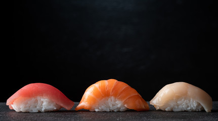 Sushi set on a black stone background, Japanese cuisine