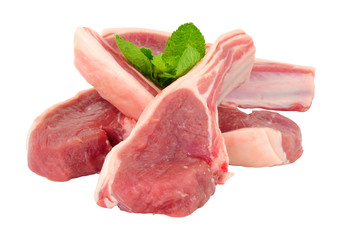 Group of fresh raw lamb cutlets with mint leaf garnish isolated on a white background