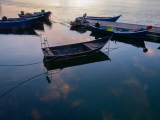 Fishing boats moored in a small pier