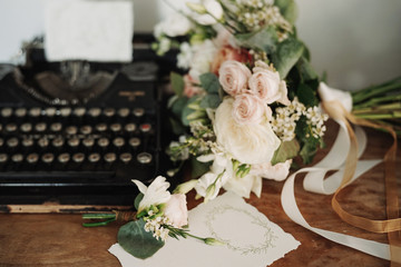 Bride's bouquet, typewriter and a set of invitations. The bride's accessories. Wedding morning....