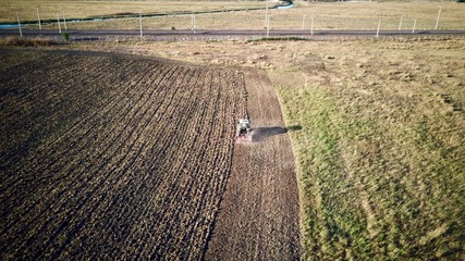 Farmer plowing his field. It plows and aerates the soil with a tractor.