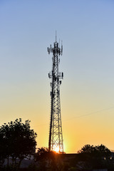 Wireless communication tower under the background of early morning sunrise