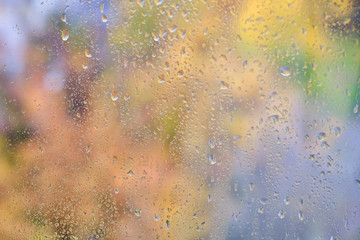Blurred background with raindrops on the window glass