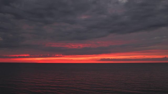 Beautiful scenic sky sunset sundown blood orange red stratocumulus cloud wide cover colour fading as clouds move Lake Huron Ontario static
