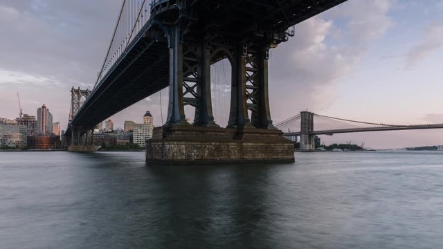 View on Manhattan bridge and Dumbo location from East river in day to night time lapse