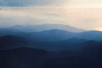 Obraz na płótnie Canvas A chain of distant blue hills at dawn