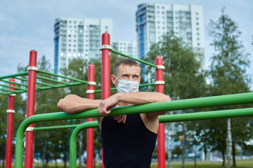 athletic man in a protective mask at practice in the morning