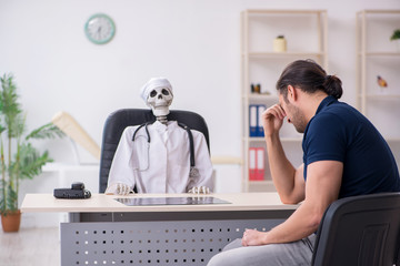 Fototapeta premium Young man visiting dead doctor
