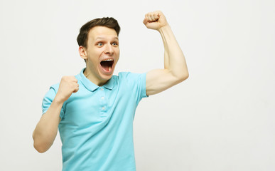 Fototapeta premium young man celebrating victory over white background