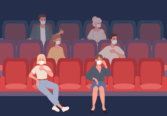 Young People sitting in the cinema in protective masks observe social distance