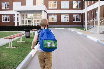 Back to school. School Boy with backpack flees and going to school with fun