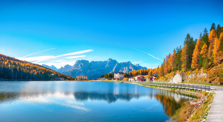 Majestic sunny view of famous Misurina lake during autumn period
