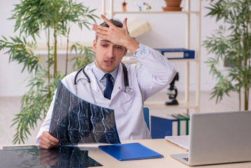 Young male doctor working in the clinic
