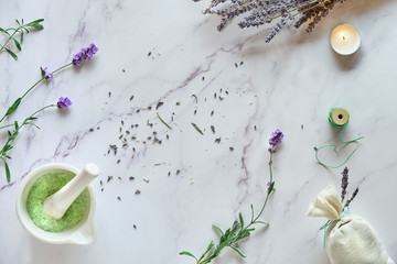 Handmade lavender bags and DIY homemade sugar scrub. Flat lay on white marble with dry and fresh...