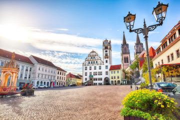 Splendid autumn cityscape of Oschatz central square with Stadtverwaltung and St. Aegidien church