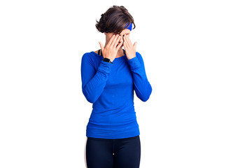 Beautiful young woman with short hair wearing training workout clothes rubbing eyes for fatigue and headache, sleepy and tired expression. vision problem