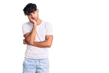 Young hispanic man wearing casual clothes thinking looking tired and bored with depression problems with crossed arms.