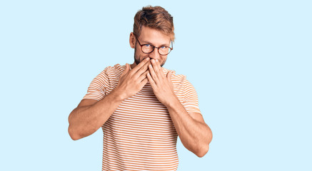 Young caucasian man wearing casual clothes and glasses laughing and embarrassed giggle covering...