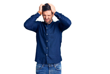 Young handsome man wearing casual shirt suffering from headache desperate and stressed because pain and migraine. hands on head.