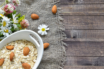 Oatmeal with almonds in a bowl top view