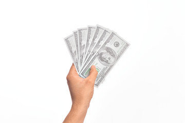 Hand of caucasian young man holding bunch of dollars banknotes over isolated white background