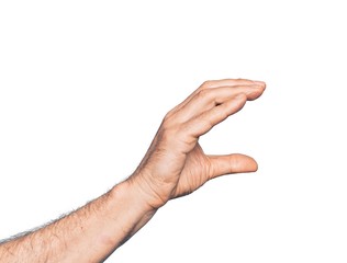 Hand of caucasian middle age man over isolated white background picking and taking invisible thing, holding object with fingers showing space