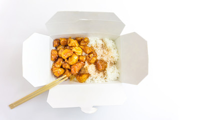 Chinese Food Sweet and Sour, Orange or Lemon Chicken in a Take Out Container with chopsticks