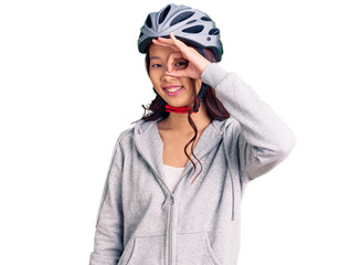 Young beautiful chinese girl wearing bike helmet smiling happy doing ok sign with hand on eye looking through fingers