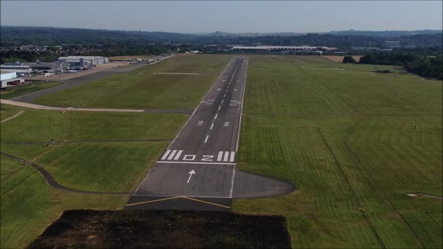 Southampton International Airport Runway zoom out, reveal aerial drone shot. UK flights, transportation. COVID-19 means lack of flights, quiet. Flybe job losses.