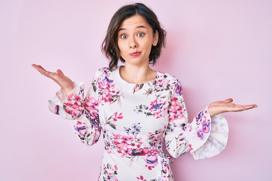 Young beautiful woman wearing casual clothes clueless and confused with open arms, no idea and doubtful face.