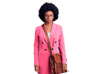 Young african american woman wearing business clothes and leather bag with serious expression on face. simple and natural looking at the camera.