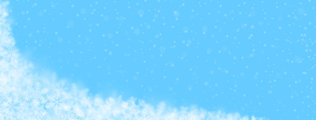 Christmas background of snowflakes of different shapes, sizes, blur and transparency on light blue background