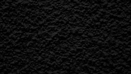 Black vesicular painted wall texture. Rough black oil color abstract decorative grunge background.