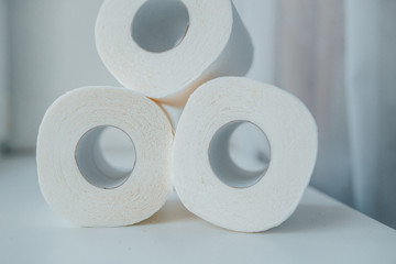 Toilet paper shortage concept with stacked rolls.