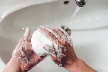 Fototapeta premium Man washing hands to protect against the coronavirus