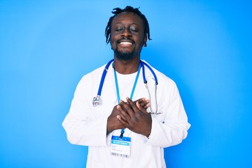 Young african american man with braids wearing doctor stethoscope and id pass smiling with hands on...