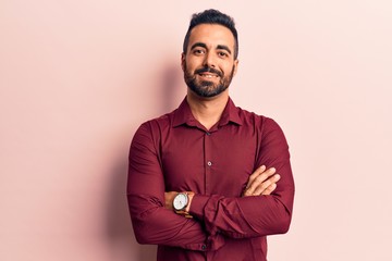 Young hispanic man wearing casual clothes happy face smiling with crossed arms looking at the camera. positive person.