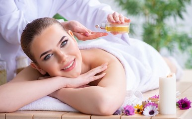Obraz na płótnie Canvas Woman during massage session in spa