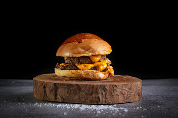 Two smash burger with cheddar cheese and garlic sauce .