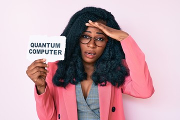 Beautiful african woman holding quantum computer banner stressed and frustrated with hand on head,...