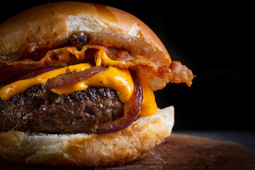 Craft beef burger with cheddar cheese, bacon, caramelized onion and garlic mustard sauce. ..