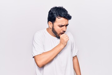 Young hispanic man wearing casual clothes feeling unwell and coughing as symptom for cold or bronchitis. health care concept.