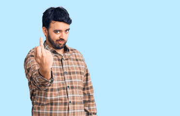 Young hispanic man wearing casual clothes showing middle finger, impolite and rude fuck off expression