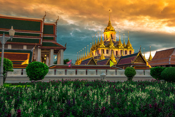 Background of tourist attractions where people come to see the beauty of the architecture of the golden pagoda in Bangkok (Wat Metal Prasat Or Wat Ratchanaddaram Worawihan) in Thailand