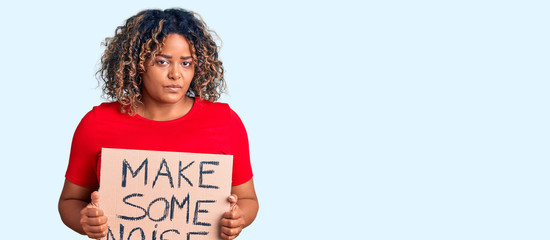 Young african american plus size woman holding make some noise banner thinking attitude and sober expression looking self confident