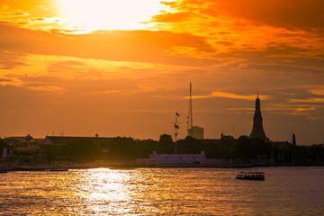 The blurred abstract background of the evening sun shining on the river is naturally golden yellow, the beauty of the clouds and the weather conditions of the day.