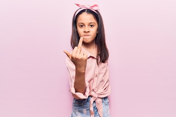 Beautiful child girl wearing casual clothes showing middle finger, impolite and rude fuck off...